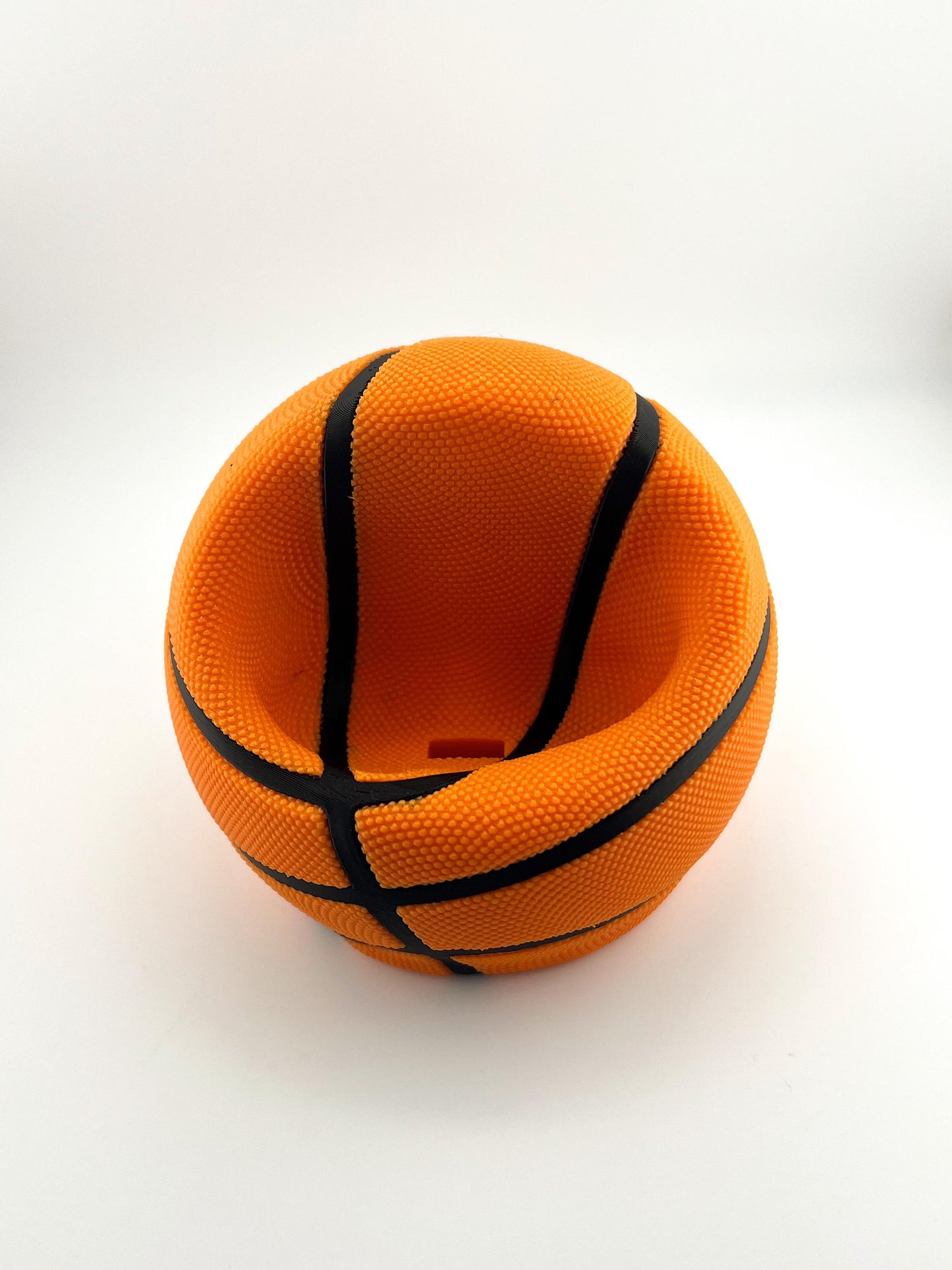 Basketball Slam Dunk Phone Holder and Charging Stand with Black Seams and Hidden Charging Cord Holder